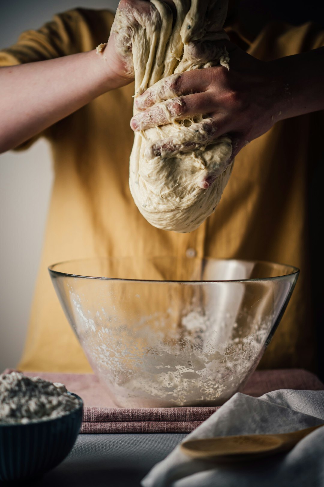 Hands of a Czech woman kneading dough on a wooden table