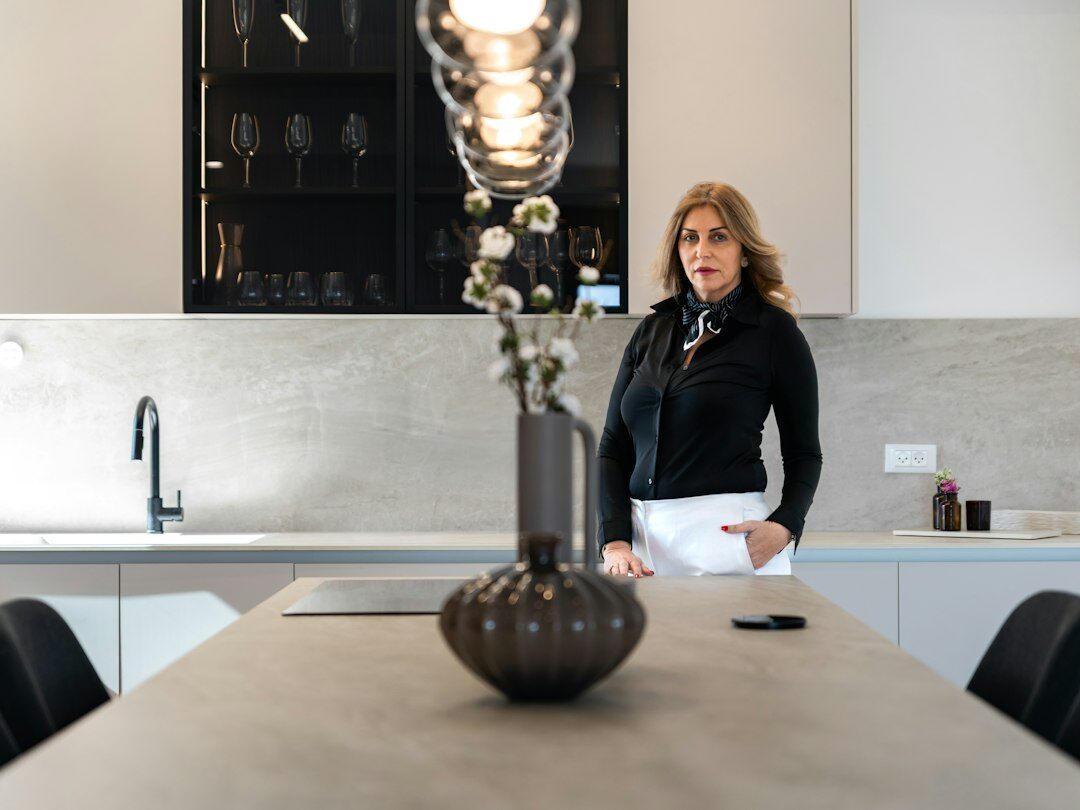 Portrait of a Czech woman in her forties smiling in a home kitchen